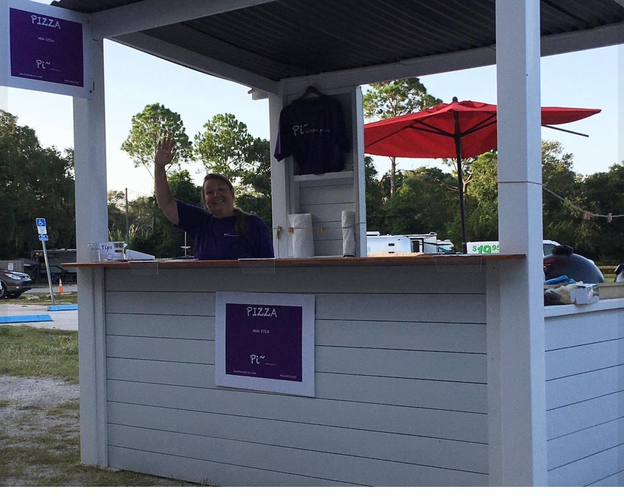 The Pi pizza stand with a friendly wave