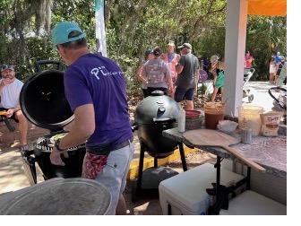 Peter firing pizzas in kamado-style ovens at a St. Augustine farmers market