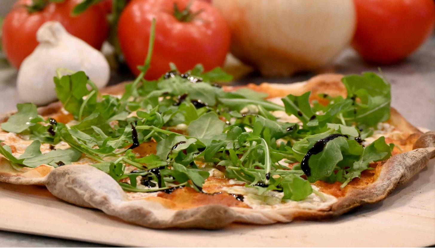 Sliced ricotta arugula pizza overhead